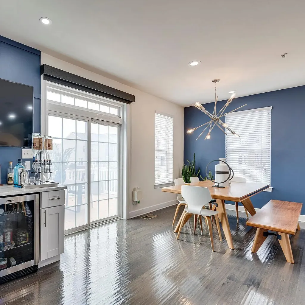 Open kitchen and dining area with polished hardwood floors after a cleaning by TCS Cleaning Service