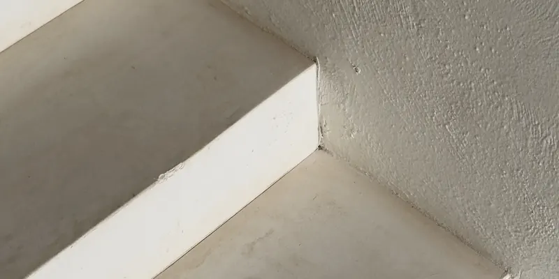 Dust-free stair edge and wall after a detailed cleaning, the kind of finishing detail that follows a renovation
