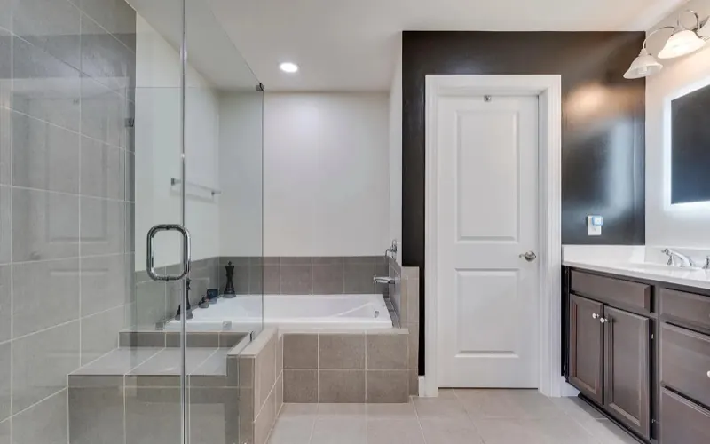 Clean glass shower and tub in a bright bathroom, the kind of detail covered in a TCS move-out cleaning