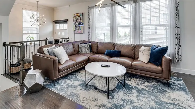 Dust-free family room with leather sectional and area rug
